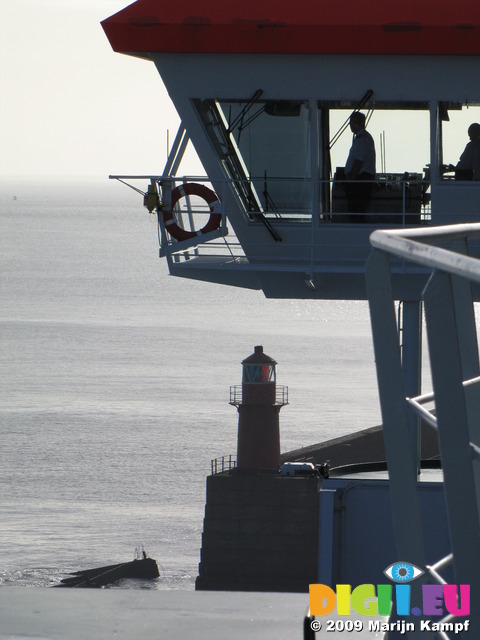 SX03018 Silhouette of captain on bridge of car ferry pulling out Rosslare harbour